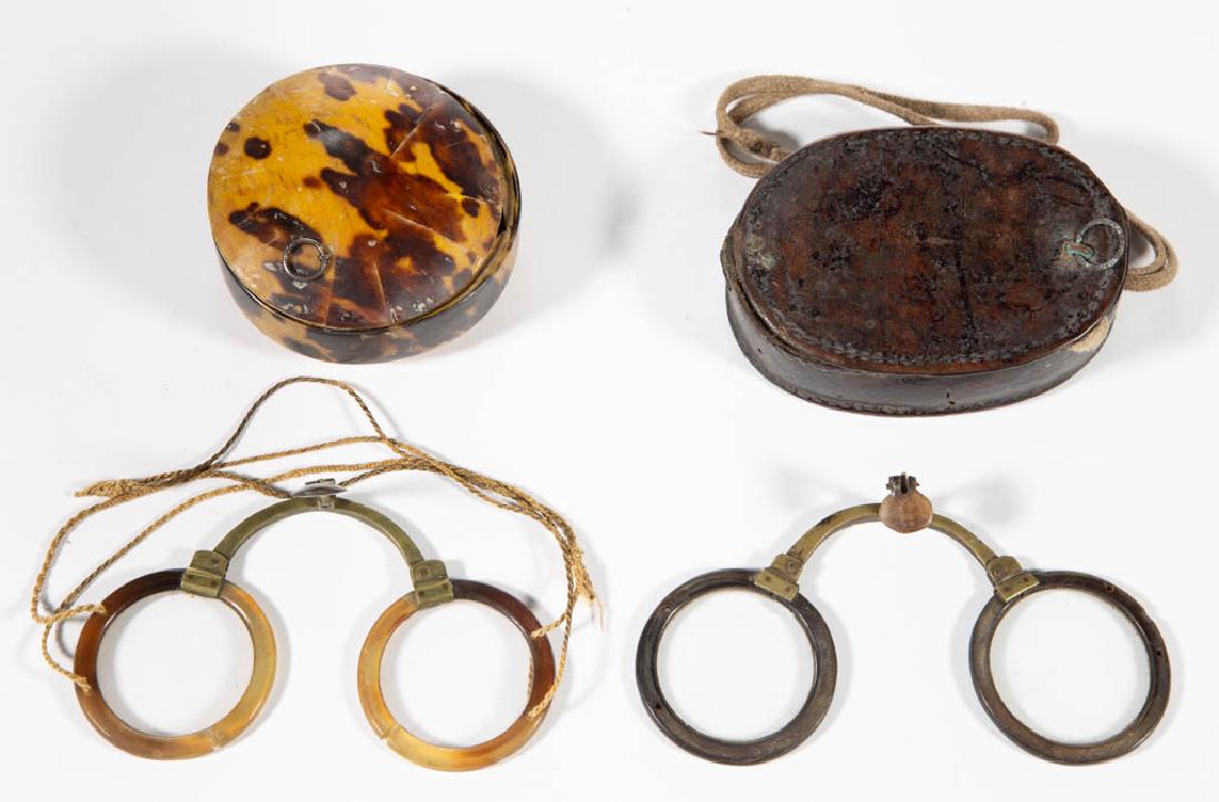 CHINESE EYEGLASSES AND CASES, LOT OF TWO: CHINESE EYEGLASSES AND CASES, LOT OF TWO, comprising a shell-like case with mottled horn-rimmed folding glasses, and a leather case with folding horn-rimmed glasses. Second half 19th/early 20th centur