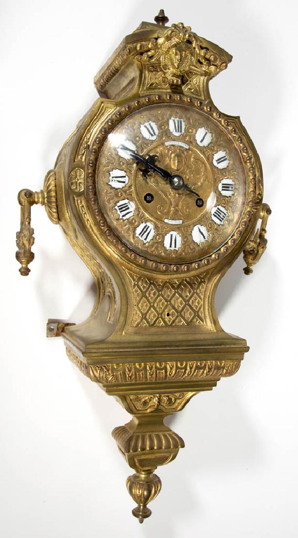 TIFFANY & COMPANY GILT BRONZE WALL / CARTEL CLOCK: TIFFANY & COMPANY GILT BRONZE WALL / CARTEL CLOCK, brass movement marked "TIFFANY & COMPY / 1149", brass dial with applied enamel numeral plaques and "TIFFANY & COMPY / New-York", back plate marked "4