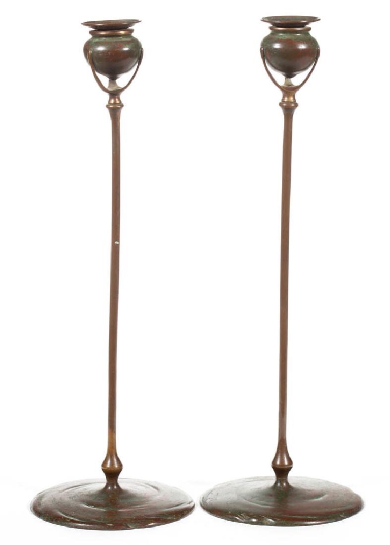 TIFFANY STUDIOS NO. 1213 BRONZE PAIR OF CANDLESTICKS: TIFFANY STUDIOS NO. 1213 BRONZE PAIR OF CANDLESTICKS, original patina, each with original socket cups and signed to the underside. Tiffany Studios. First quarter 20th century. 16 1/2" HOA, 5 3/4" D fe