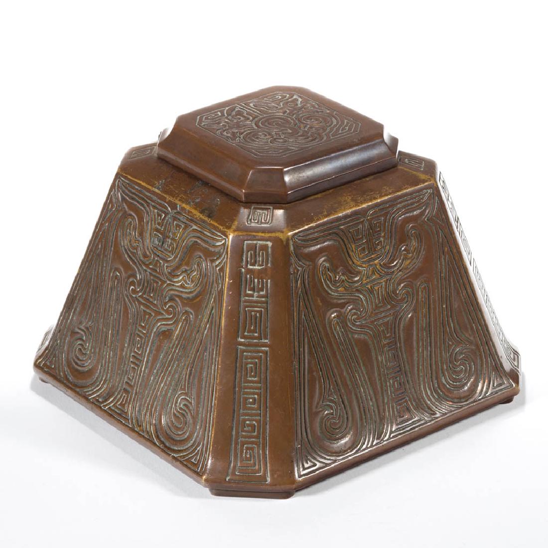 TIFFANY STUDIOS NO. 1753 / CHINESE BRONZE LARGE INKWELL: TIFFANY STUDIOS NO. 1753 / CHINESE BRONZE LARGE INKWELL, original patina, original glass insert, signed. Tiffany Studios. First quarter 20th century. 4 3/8" H, 6 1/4" SQ.Good condition overall with so