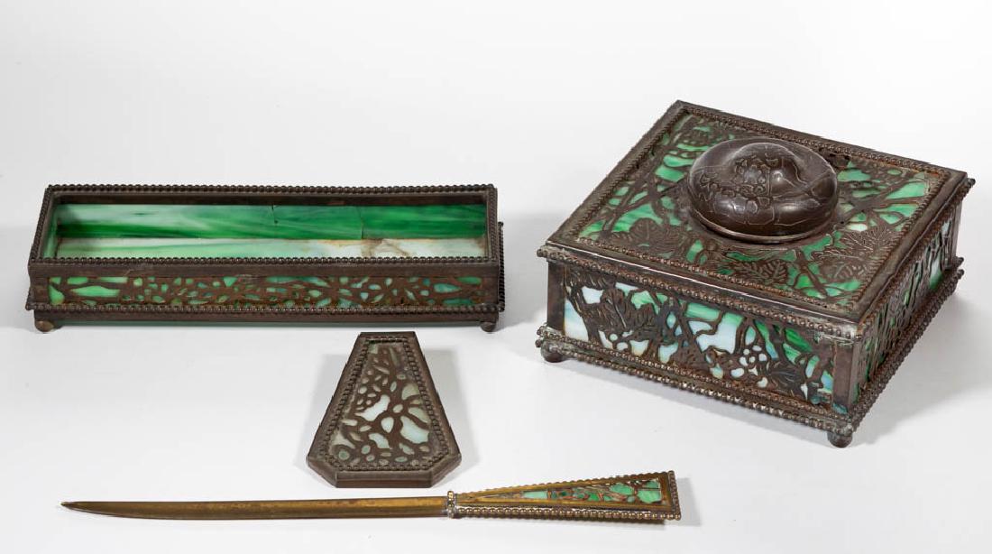 RIVIERE STUDIOS GRAPEVINE DESK ARTICLES, LOT OF FOUR: RIVIERE STUDIOS GRAPEVINE DESK ARTICLES, LOT OF FOUR, green slag glass, comprising an inkwell with glass insert, letter opener, part of a clip, and pen tray. New York. Early 20th century. Inkwell: 3 1