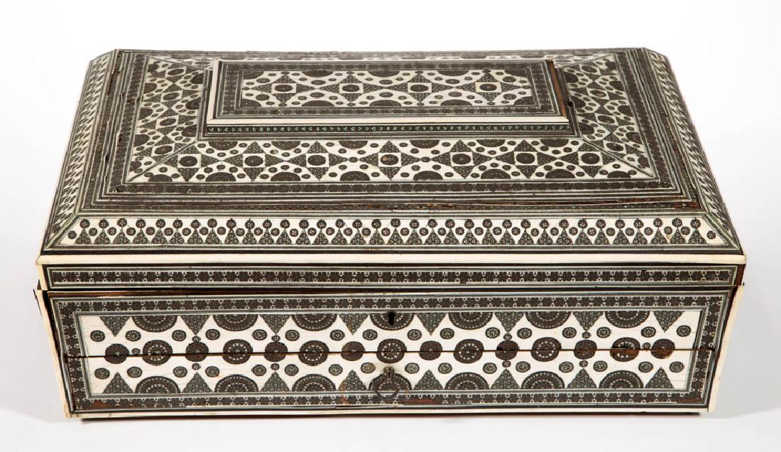 ANGLO INDIAN SADELI SEWING BOX: ANGLO INDIAN SADELI SEWING BOX, mosaic design with inlaid bone, hinged top concealing a fitted interior with mirror, full-length drawer with fabric lined writing surface. 19th century. 7 1/4" H, 17" W
