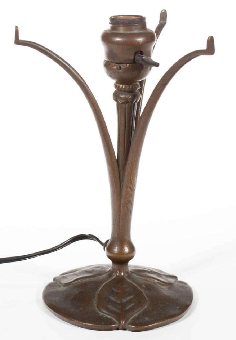 TIFFANY STUDIOS NO. 426 BRONZE ELECTRIC TABLE LAMP: TIFFANY STUDIOS NO. 426 BRONZE ELECTRIC TABLE LAMP, original patina, circular foot with three leaves extending in different directions, three arms extending out to hold a domed shade, original socket.