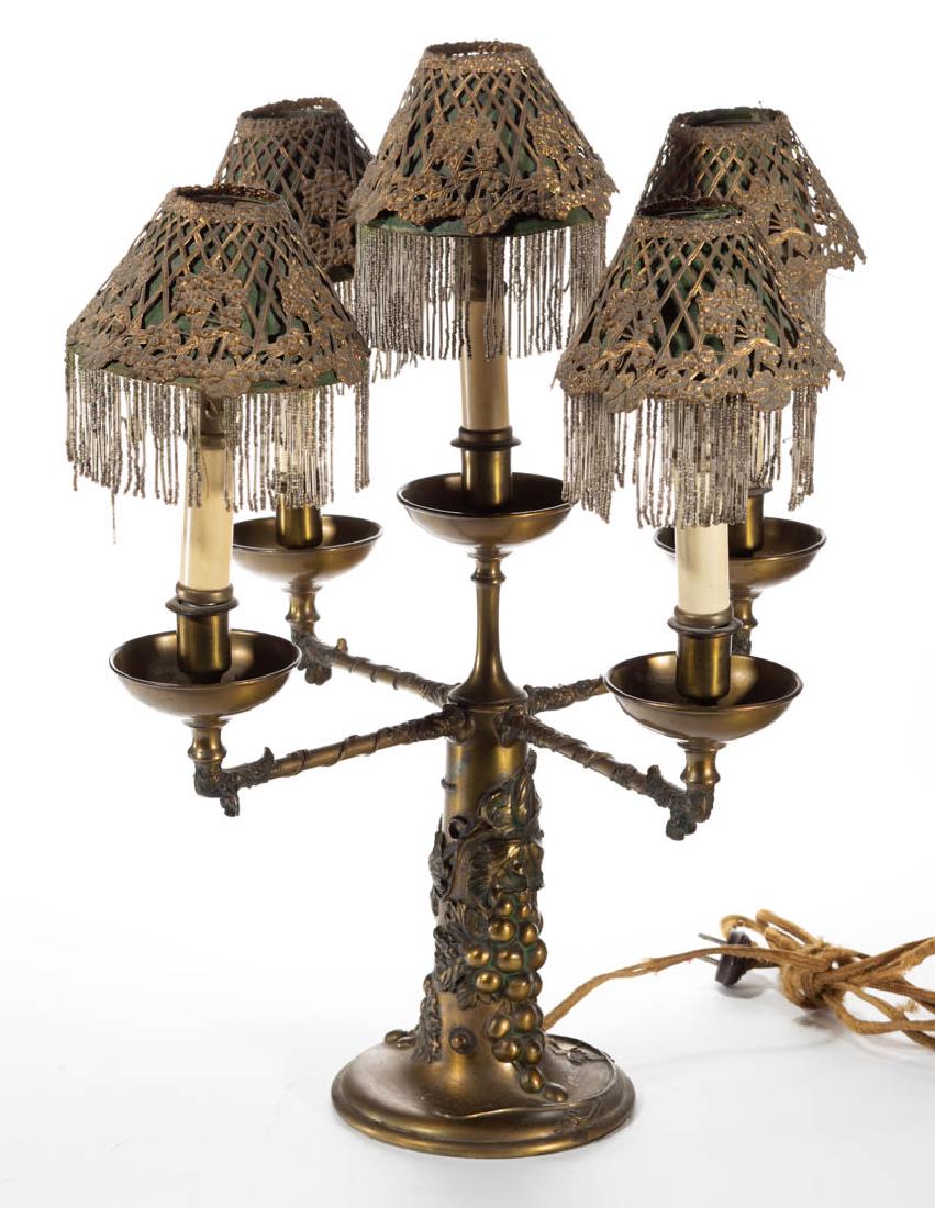 PAIRPOINT EMBOSSED GRAPE AND VINE BRASS ELECTRIC: PAIRPOINT EMBOSSED GRAPE AND VINE BRASS ELECTRIC CANDELABRA LAMP, base with a grape and vine motif supporting four extending arms with crawling vine decoration, five candle sockets with each having a 
