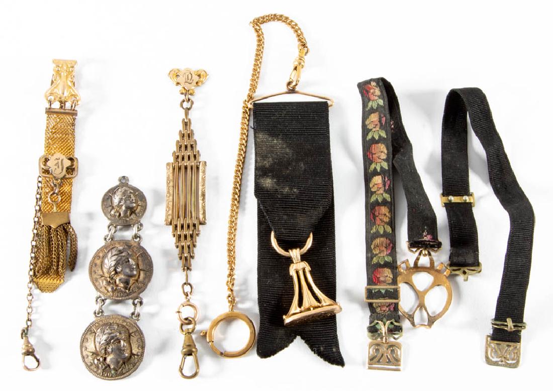 ANTIQUE WATCH FOBS, LOT OF SIX: ANTIQUE WATCH FOBS, LOT OF SIX, varying in style, including one example having a black ribbon and a pendant with engraved "FMH" monogram, handle of pendant tested as 14K. Late 19th/early 20th century.