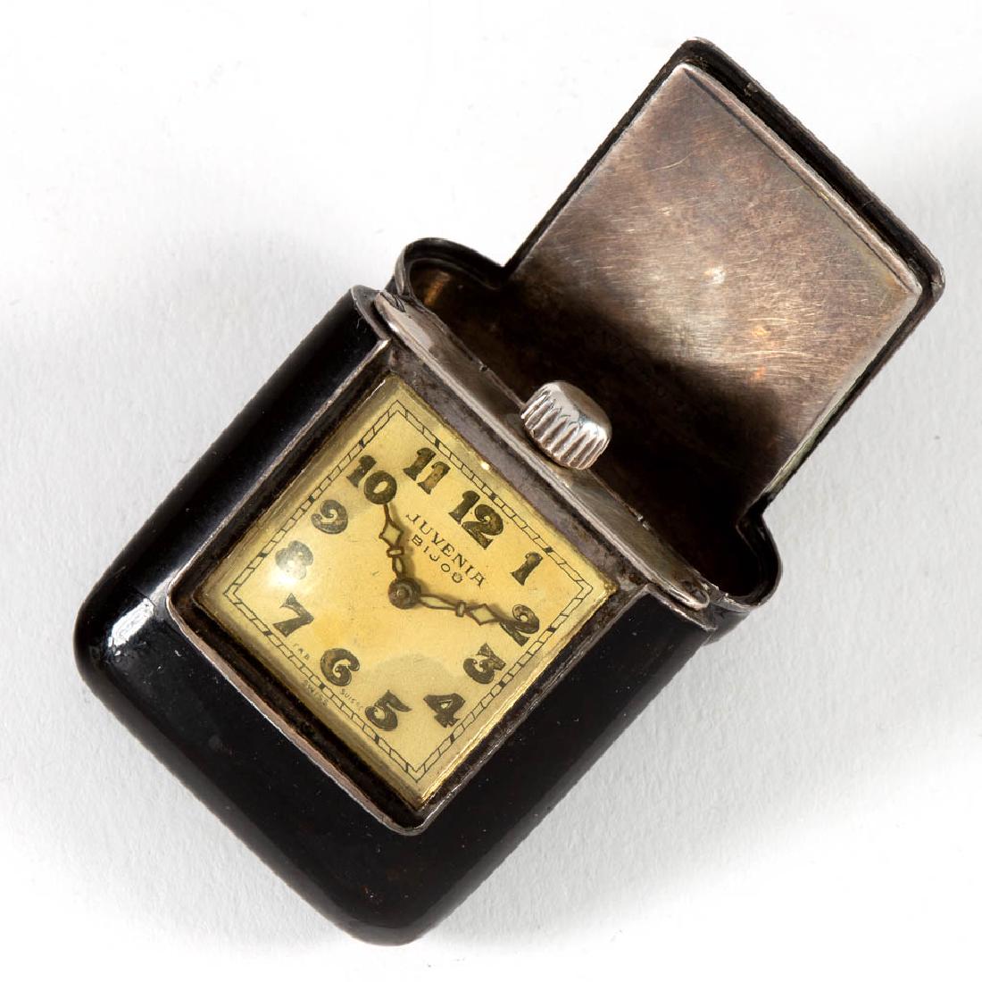 SWISS ART DECO SILVER AND ENAMEL MINIATURE TRAVEL CLOCK: SWISS ART DECO SILVER AND ENAMEL MINIATURE TRAVEL CLOCK, dial marked "JUVENIA / BIJOU / FAB SUISSE / SWISS". Circa 1920. 1 1/2" x 1 1/4" (closed).Dial with some discoloration. Minor wear to enamel. Cu