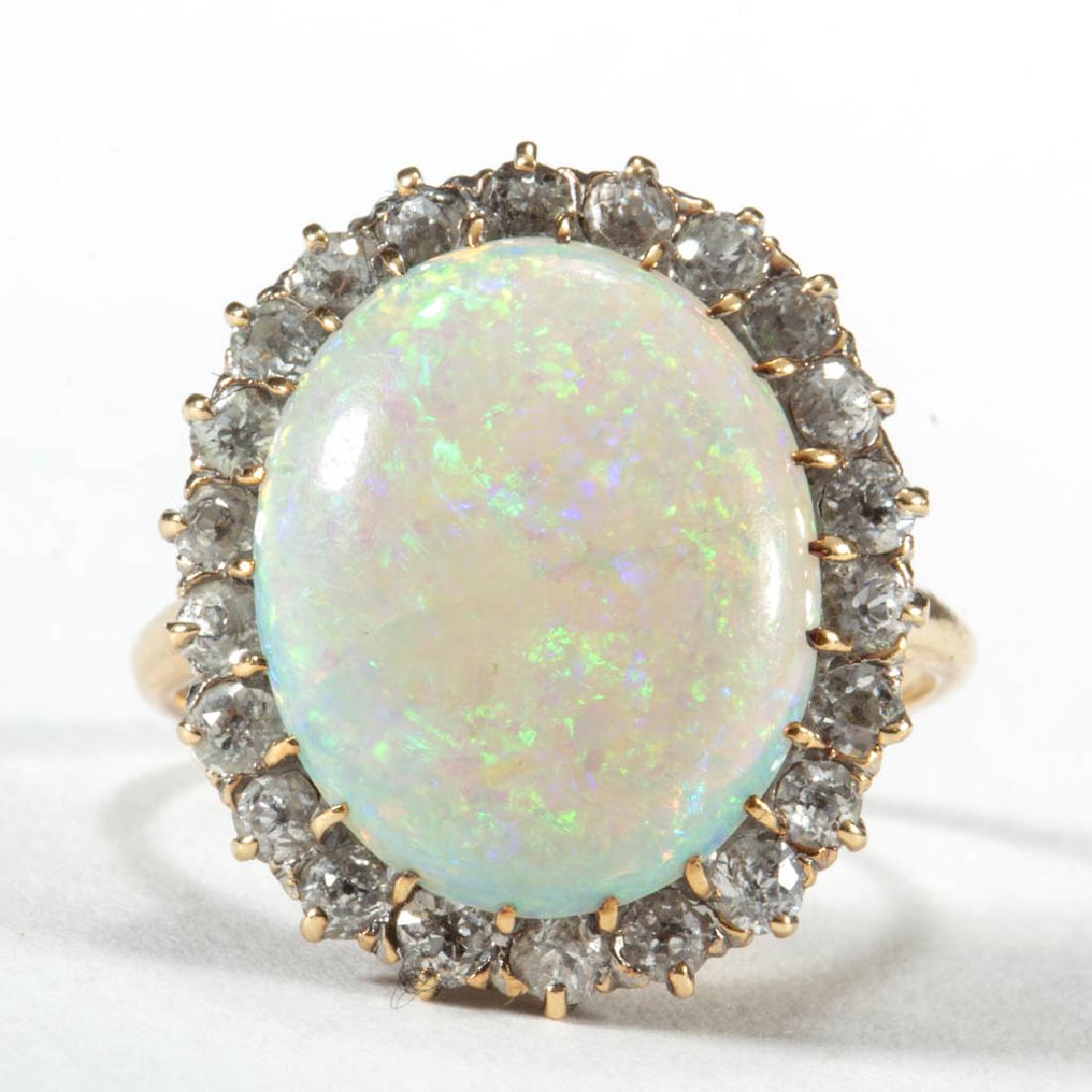 VINTAGE 14K YELLOW GOLD, OPAL, AND DIAMOND LADY'S RING: VINTAGE 14K YELLOW GOLD, OPAL, AND DIAMOND LADY'S RING, single oval opal cabochon measuring approximately 14.8 mm x 12.0 mm x 3.4 mm, estimated weight of 3.51 ct., having white background color, green