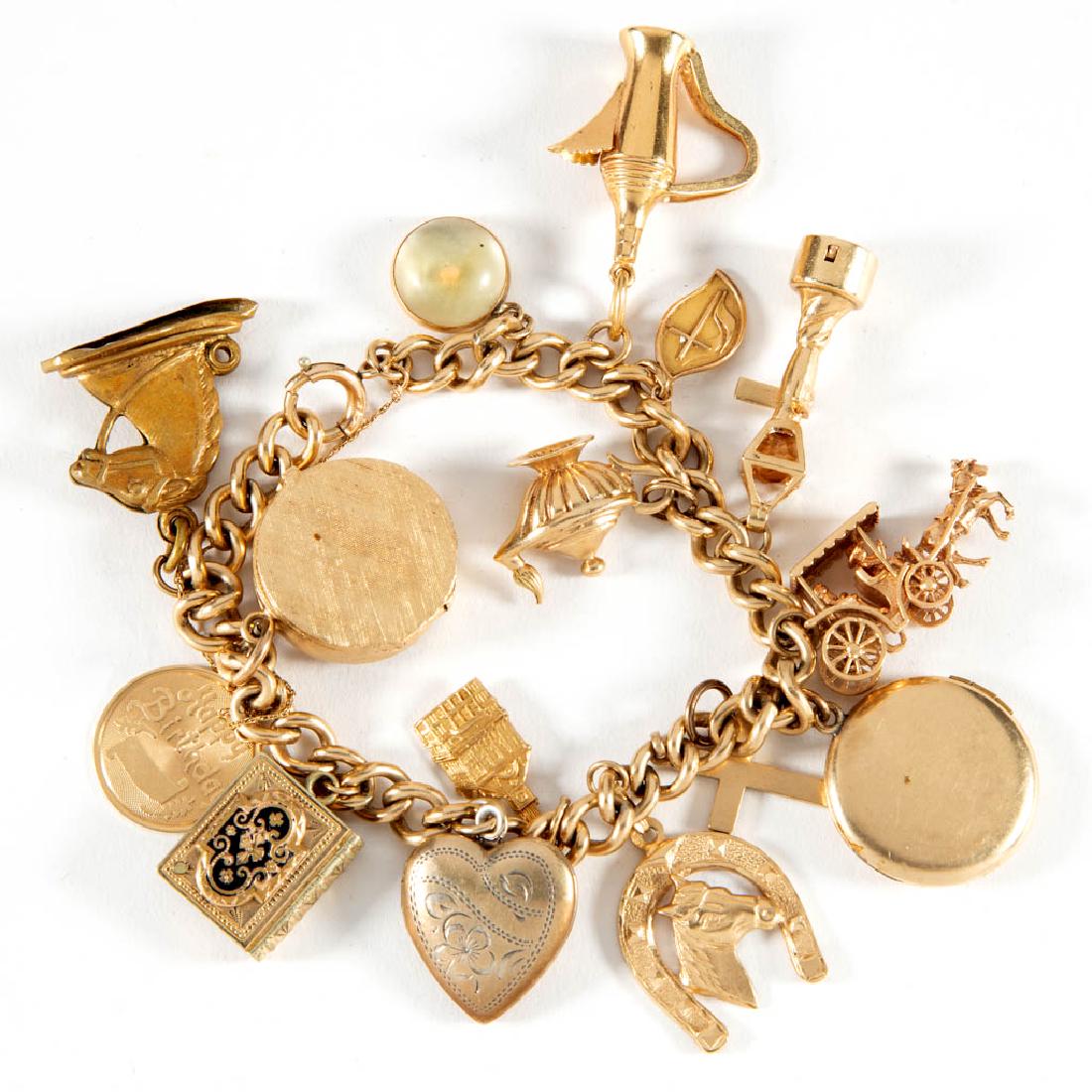 VINTAGE GOLD-FILLED CHARM BRACELET WITH GOLD AND OTHER: VINTAGE GOLD-FILLED CHARM BRACELET WITH GOLD AND OTHER CHARMS, curb chain with a spring ring clasp and an attached 14K safety chain, 15 charms comprising a marked "750" 18K coffee pot, eight various 1