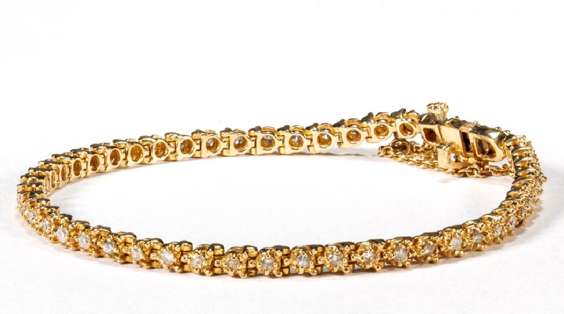 14K YELLOW GOLD AND DIAMOND LINE BRACELET: 14K YELLOW GOLD AND DIAMOND LINE BRACELET, having 50 round-cut melee diamonds, each in prong setting, box tab clasp with lock and safety chain. "14K" mark to clasp. Total weight: 9.7 grams. 20th centu