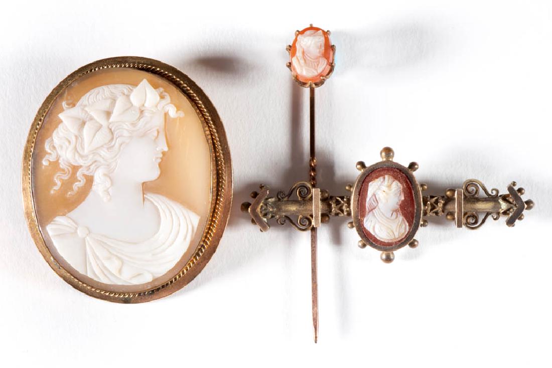 ANTIQUE VICTORIAN CAMEO JEWELRY, LOT OF THREE: ANTIQUE VICTORIAN CAMEO JEWELRY, LOT OF THREE, comprising a large shell brooch in a gold-filled bezel setting, a bar pin/brooch with stone cameo, and a stick pin with stone cameo. Unmarked. Late 19th/