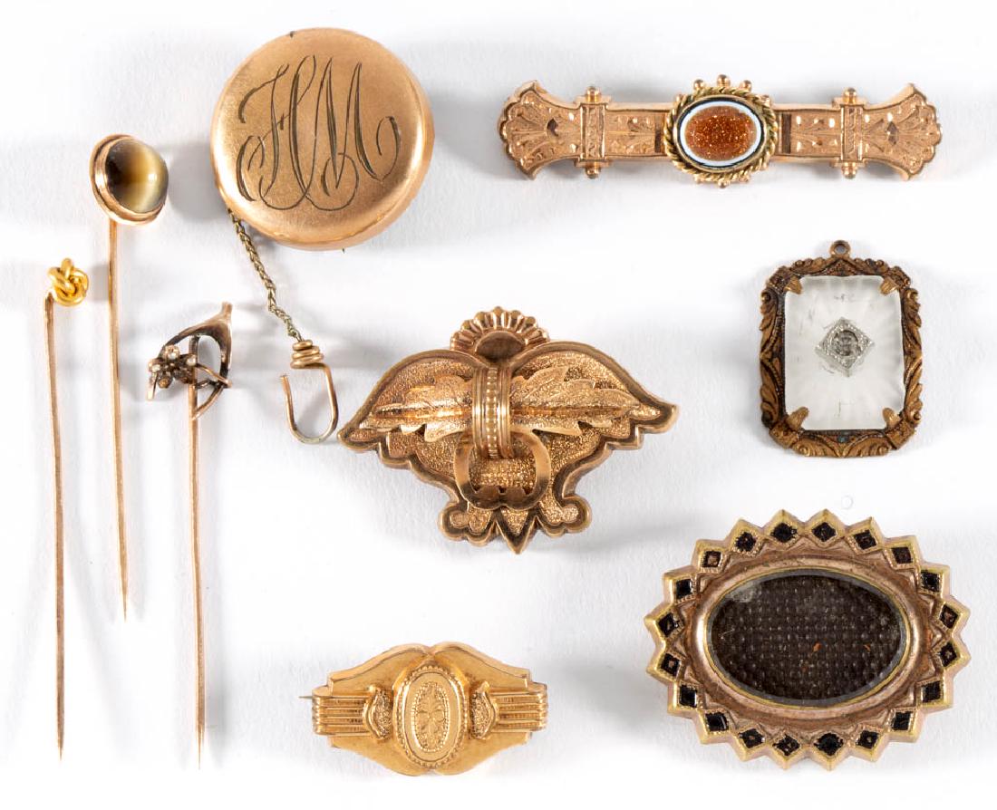 ANTIQUE AND VINTAGE GOLD-FILLED / GOLD-TONED JEWELRY,: ANTIQUE AND VINTAGE GOLD-FILLED / GOLD-TONED JEWELRY, LOT OF NINE, comprising four brooches/pins, a pendant, a watch fob with engraved "HM" initials, and three stick pins with one having a cat's-eye q