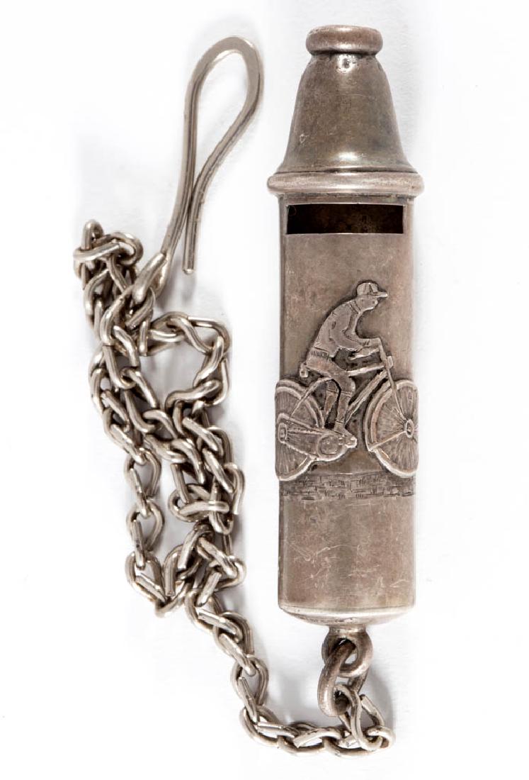 HAYDEN MFG. CO. STERLING SILVER CYCLIST WHISTLE: HAYDEN MFG. CO. STERLING SILVER CYCLIST WHISTLE, having raised decoration of a man on a bicycle, engraved foliate accents, and engraving of "ORIENT CYCLE CLUB / August 22, 1896.", attached to a non-st