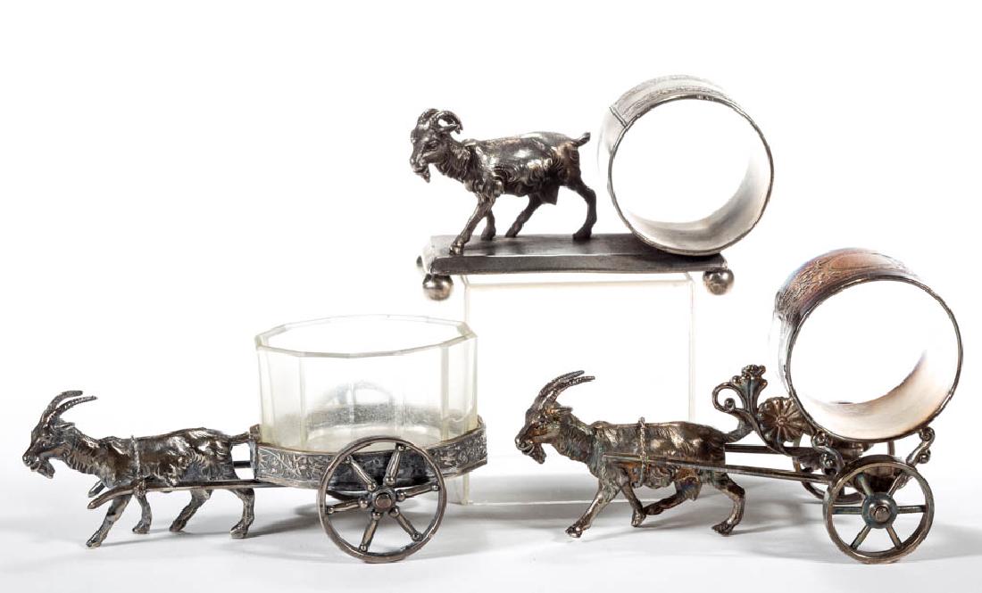 GOAT FIGURAL SILVER-PLATED NAPKIN RINGS AND OPEN SALT,: GOAT FIGURAL SILVER-PLATED NAPKIN RINGS AND OPEN SALT, LOT OF THREE, comprising a napkin ring on a rectangular base with spherical feet by Meriden Britannia Co., a napkin ring cart example by Rogers,