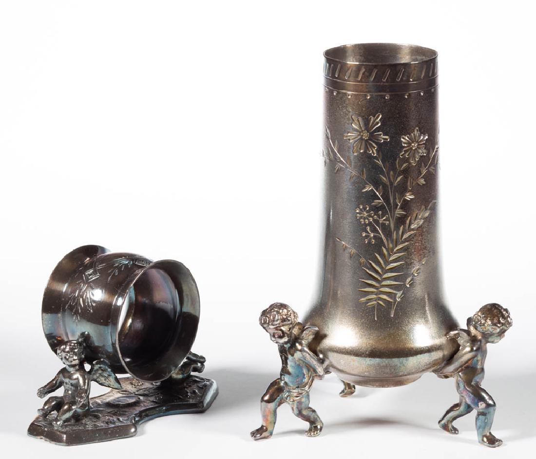 CHERUB FIGURAL SILVER-PLATED NAPKIN RING AND VASE, LOT: CHERUB FIGURAL SILVER-PLATED NAPKIN RING AND VASE, LOT OF TWO PIECES, napkin ring by E.G. Webster & Son having two cherubs, vase by Meriden Britannia Co. with floral-decorated sides and three cherub f