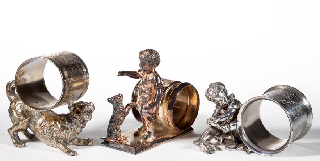 ASSORTED FIGURAL SILVER-PLATED NAPKIN RINGS, LOT OF: ASSORTED FIGURAL SILVER-PLATED NAPKIN RINGS, LOT OF THREE, comprising a "199" example by Meriden Britannia Co. of a boy and dog, a "341" example by Derby Silver Co. with a boy taking off his socks and