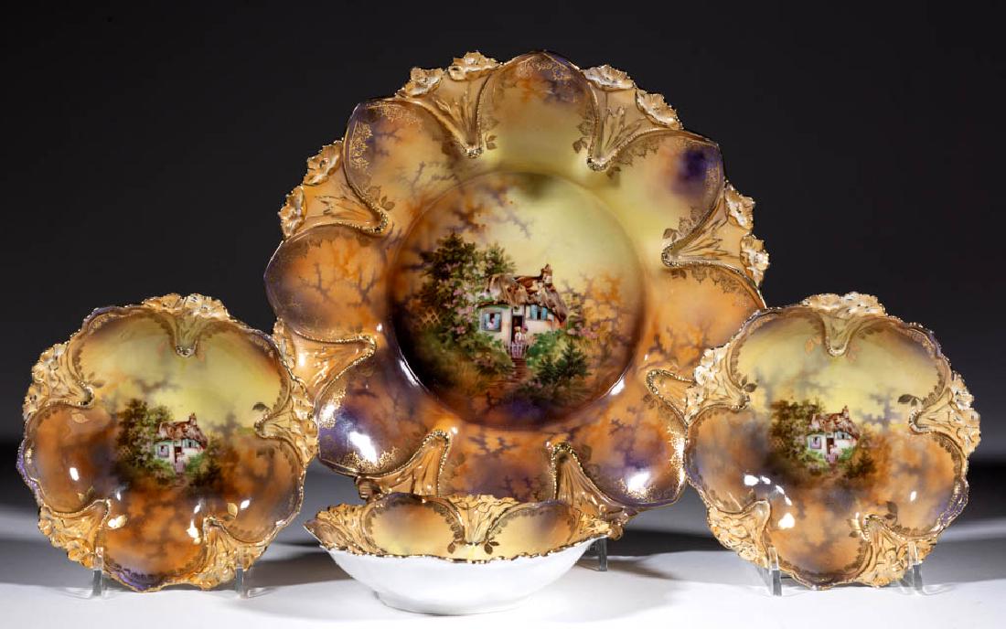 R.S. PRUSSIA PORCELAIN FOUR-PIECE BERRY SET: R.S. PRUSSIA PORCELAIN FOUR-PIECE BERRY SET, comprising one master and three individual 5 5/8" D bowls, each having quaint cottage scene on brown and yellow ground, with molded Art Nouveau-style flowe