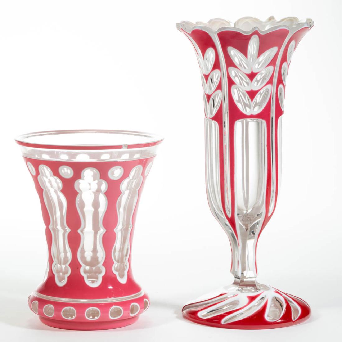 ASSORTED BOHEMIAN CUT DOUBLE-OVERLAY ARTICLES, LOT OF: ASSORTED BOHEMIAN CUT DOUBLE-OVERLAY ARTICLES, LOT OF TWO, rose to opaque white to colorless, comprising a vase with a floral motif and swirl-cut foot, and a beaker with elongated Moorish windows and 
