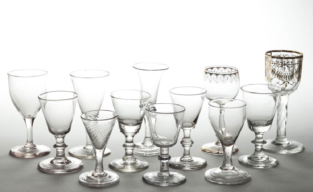 ASSORTED FREE-BLOWN GLASS WINES, LOT OF 12: ASSORTED FREE-BLOWN GLASS WINES, LOT OF 12, colorless, including two gilt-decorated examples, a trumpet-form bowl, and five with button-knop stem; gilt-decorated with a plain base, one with a polished