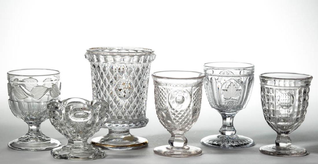 ASSORTED FLINT EAPG ARTICLES, LOT OF SIX: ASSORTED FLINT EAPG ARTICLES, LOT OF SIX, colorless lead glass, including an Inverted Sawtooth spoon holder, a Horn of Plenty egg cup, a Frosted Leaf egg cup, and a Bullseye and Fleur-de-Lis open salt