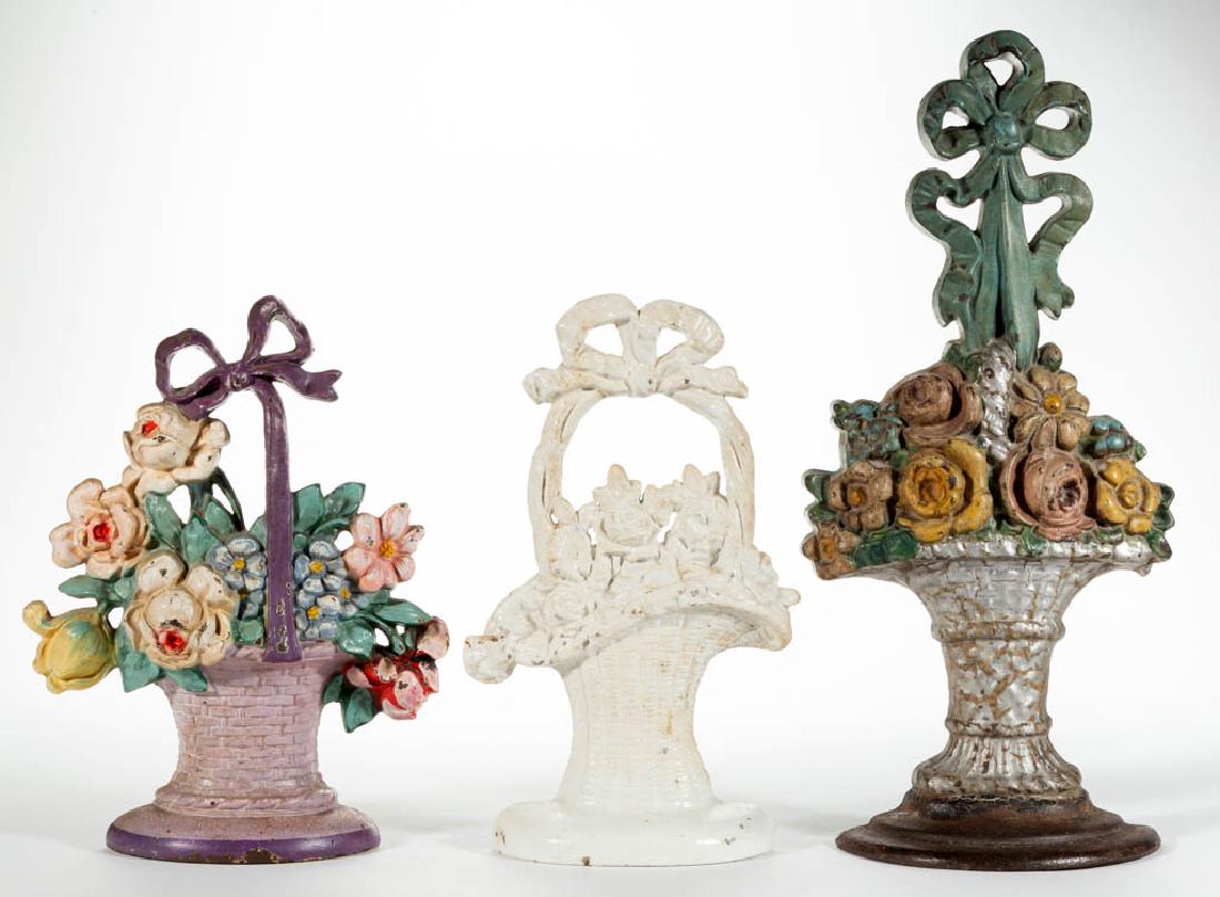 CAST-IRON FIGURAL FLOWER BASKET DOORSTOPS, LOT OF THREE (1 of 2)