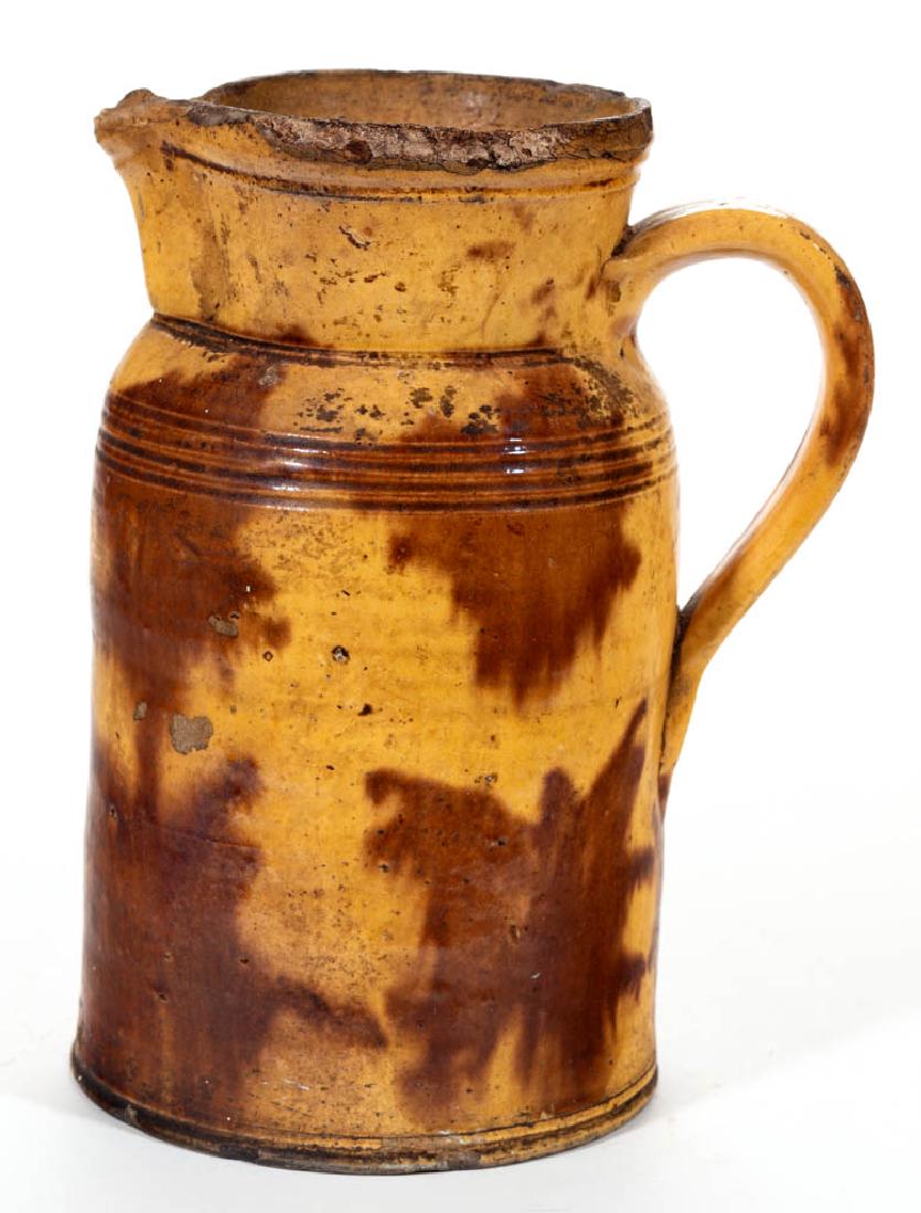 AMERICAN DECORATED EARTHENWARE / REDWARE PITCHER: AMERICAN DECORATED EARTHENWARE / REDWARE PITCHER, lead-glazed, approximately one-gallon capacity, cylindrical form having slightly flaring neck with incised ring below the rim, four incised shoulder r