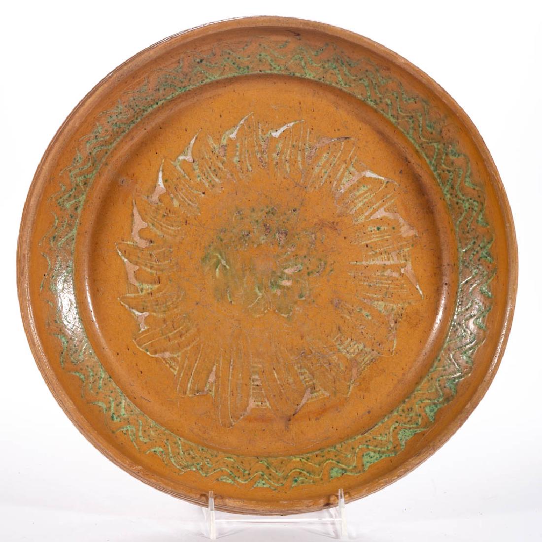 UNIDENTIFIED SLIP-DECORATED EARTHENWARE / REDWARE: UNIDENTIFIED SLIP-DECORATED EARTHENWARE / REDWARE CHARGER, lead-glazed, semi-deep form featuring yellow-slipped decoration with sponged copper oxide glaze, double incised rim and unglazed base. First