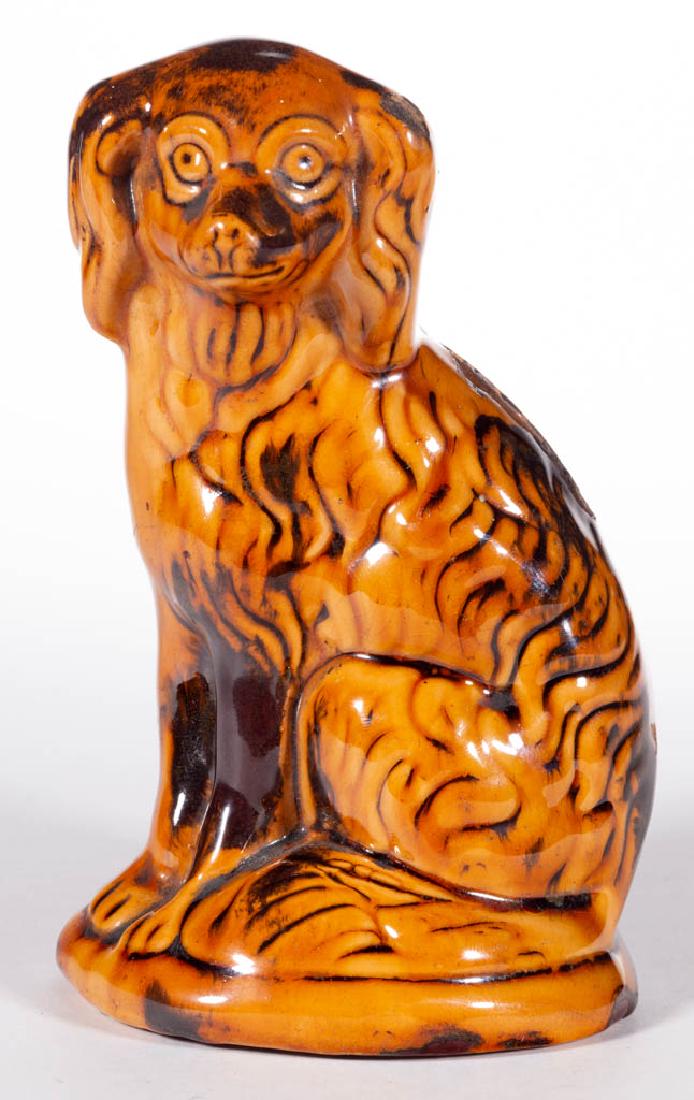 AMERICAN DECORATED EARTHENWARE / REDWARE SPANIEL: AMERICAN DECORATED EARTHENWARE / REDWARE SPANIEL FIGURAL MONEY BANK, lead-glazed, seated form on an oval base with coin slot to back. Decorated with manganese splotches. Probably Pennsylvania or Ohio.