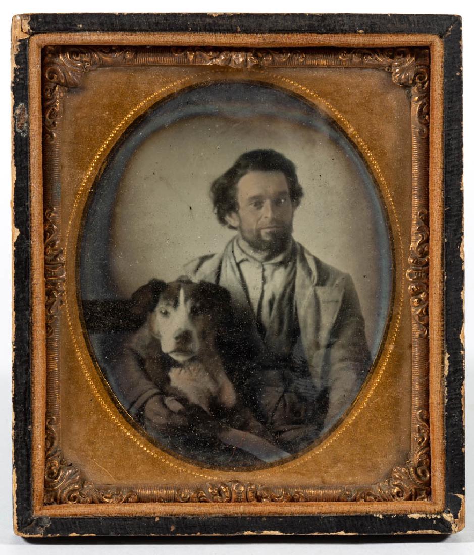 SIXTH-PLATE AMBROTYPE PORTRAIT OF A MAN AND DOG: SIXTH-PLATE AMBROTYPE PORTRAIT OF A MAN AND DOG, waist-length depiction of a bearded figure holding a dog partially astride his lap, housed in an embossed-leather half snap case. Mid 19th century. 3 5