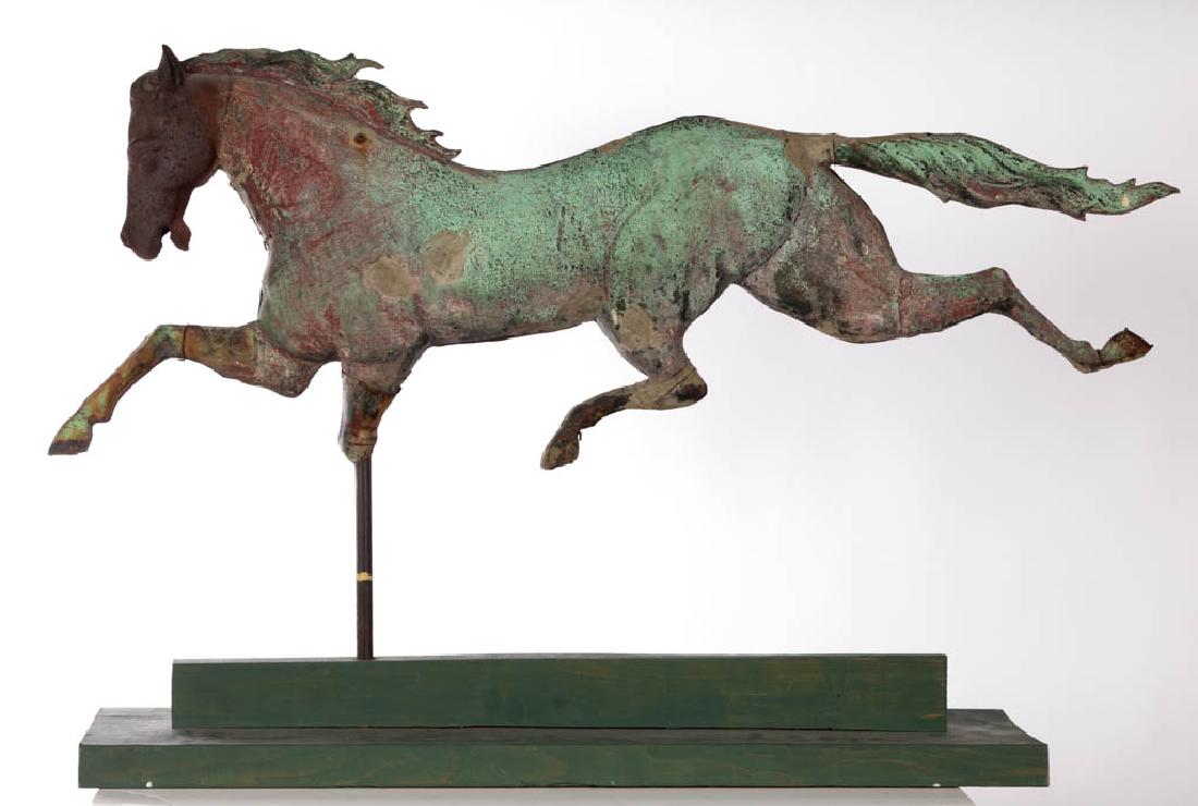 AMERICAN FULL-BODY MOLDED-COPPER RUNNING HORSE: AMERICAN FULL-BODY MOLDED-COPPER RUNNING HORSE WEATHERVANE, cast-iron head, currently mounted on a custom green wooden stand. Retains traces of verdigris surface. Circa 1880. 26 1/4" HOA, 36" LOA.Fair