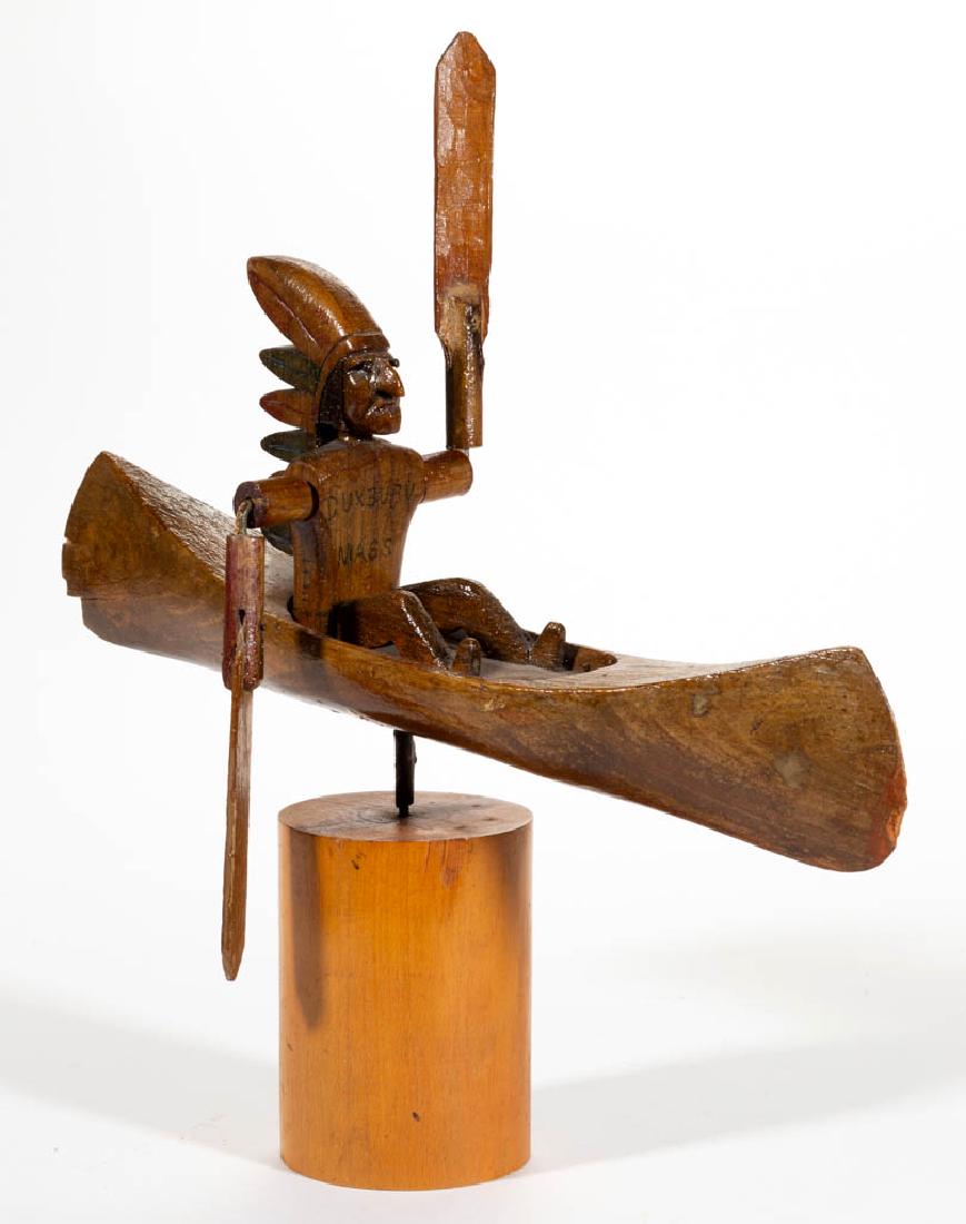 FOLK ART CARVED AND PAINTED WHIRLIGIG: FOLK ART CARVED AND PAINTED WHIRLIGIG, depicting a Native American Chief in a canoe, with "DUXBURY / MASS" written on his chest, applied to later stand. Retains an old-refinished surface, with remnant
