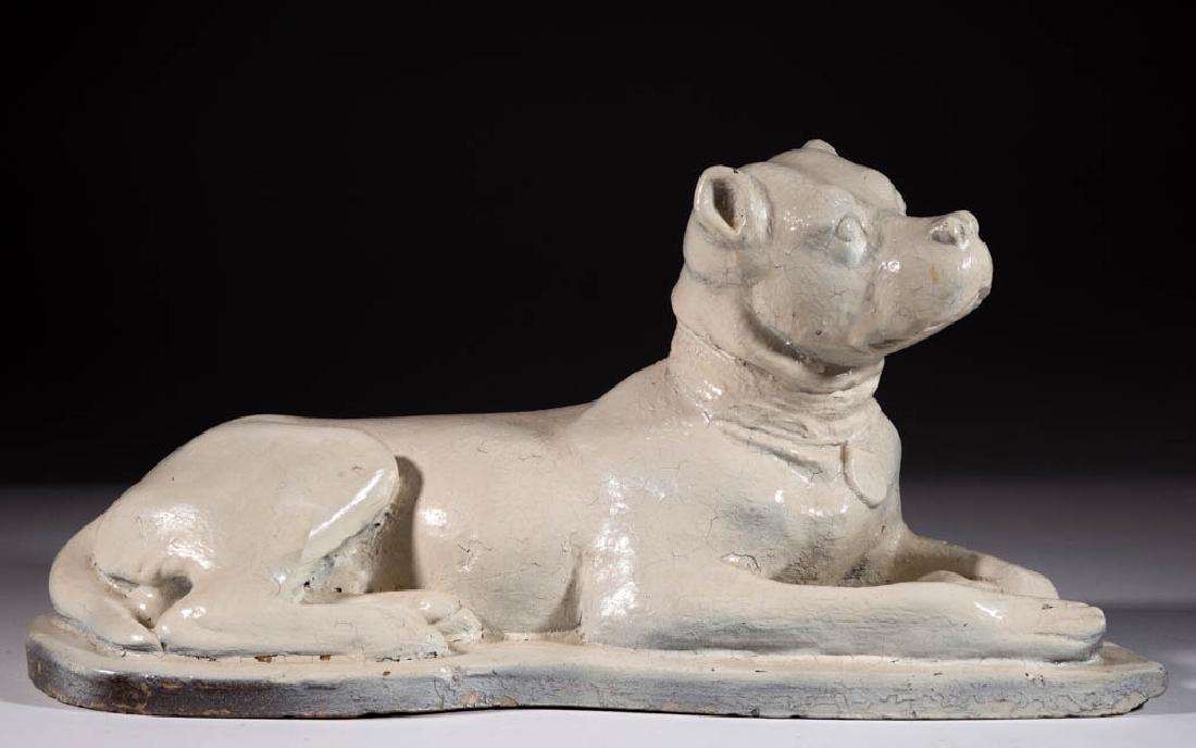 AMERICAN FOLK ART EARTHENWARE / REDWARE FIGURE OF A DOG: AMERICAN FOLK ART EARTHENWARE / REDWARE FIGURE OF A DOG, molded recumbent form with lock and collar, possibly a boxer or American bulldog. Retains a later white-painted surface. Probably Pennsylvania.