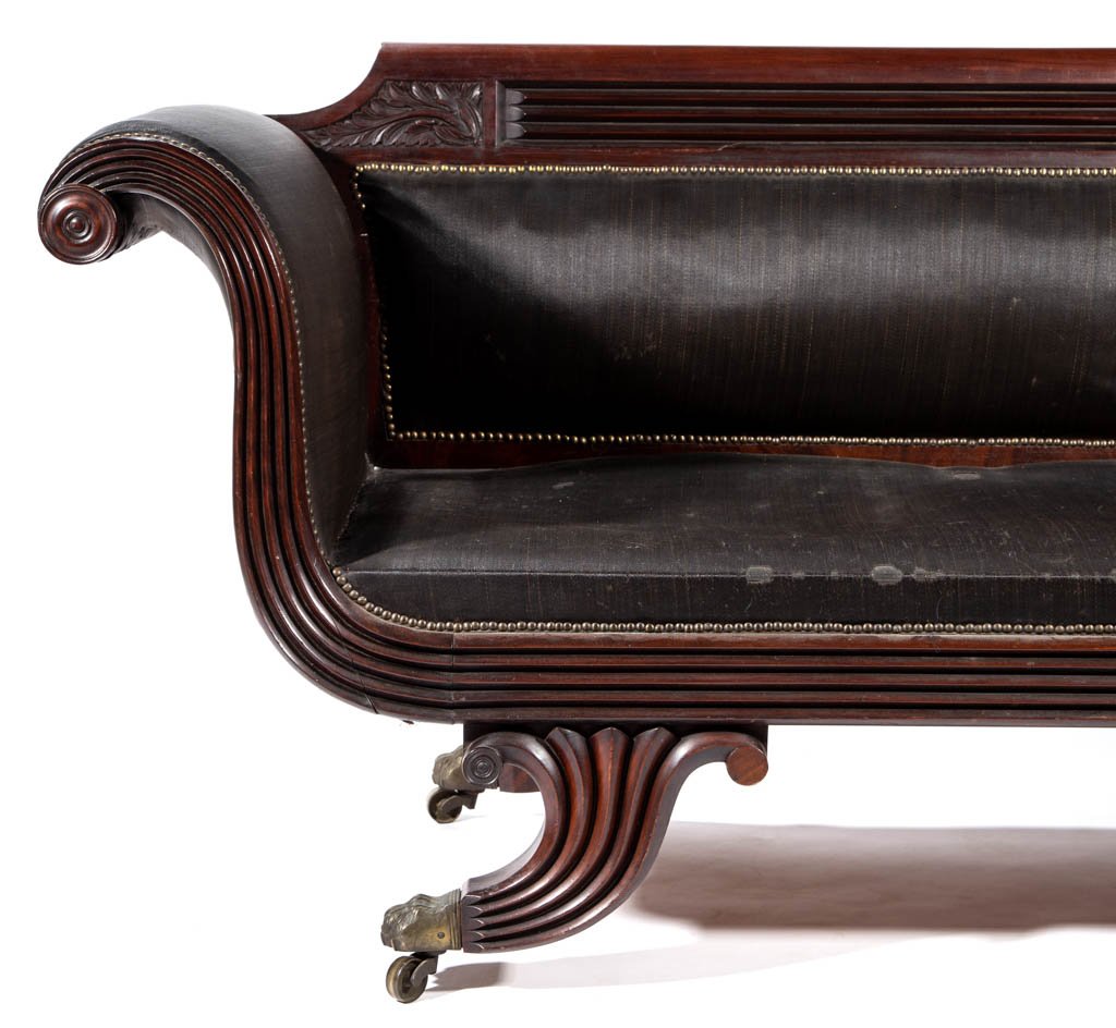 BALTIMORE CLASSICAL CARVED MAHOGANY SOFA: BALTIMORE CLASSICAL CARVED MAHOGANY SOFA, featuring rolled crest rail above reeded tablet flanked by acanthus-carved panels, serpentine arm rests and Grecian-style legs ending in cast-brass paw feet, 