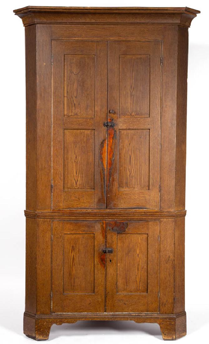 MID-ATLANTIC PAINT-DECORATED WALNUT CORNER CUPBOARD: MID-ATLANTIC PAINT-DECORATED WALNUT CORNER CUPBOARD, one-piece construction, canted returns, upper case with cove-molded cornice over two hinged double-fielded-panel doors concealing three fixed shelv