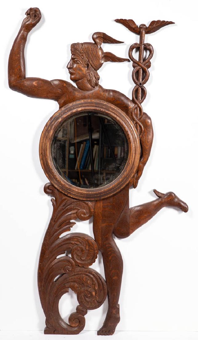 AMERICAN ARTS AND CRAFTS CARVED OAK FIGURAL COAT RACK /: AMERICAN ARTS AND CRAFTS CARVED OAK FIGURAL COAT RACK / MIRROR, depicting Mercury with winged helmet, supporting a circular beveled mirror in front of his body and Caduceus with his left arm, his righ
