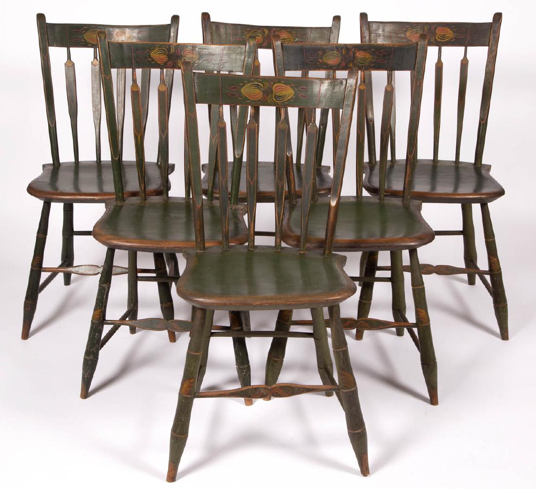 SET OF SIX AMERICAN PAINT-DECORATED PLANK-SEAT SIDE: SET OF SIX AMERICAN PAINT-DECORATED PLANK-SEAT SIDE CHAIRS, Windsor arrowback forms, each having four-spindle back, shaped plank seat, and turned, slightly splayed legs joined with box stretcher. Reta