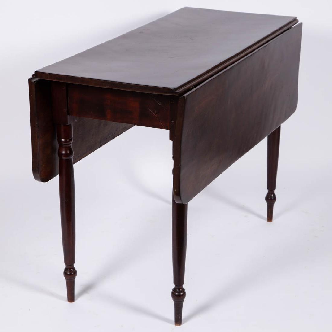 AMERICAN BIRCH FALL-LEAF DINING TABLE: AMERICAN BIRCH FALL-LEAF DINING TABLE, rectangular top with two drop leaves, leaves held open with swivel support set into center, raised on four finely turned legs. Retains an old refinished surface 