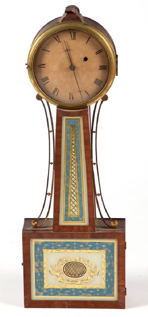 AMERICAN FEDERAL INLAID MAHOGANY BANJO CLOCK: AMERICAN FEDERAL INLAID MAHOGANY BANJO CLOCK, 8-day brass movement, having reverse-painted tablets, mahogany case with pierced-brass side arms, painted metal dial, pendulum present, lacking key. Mid 1