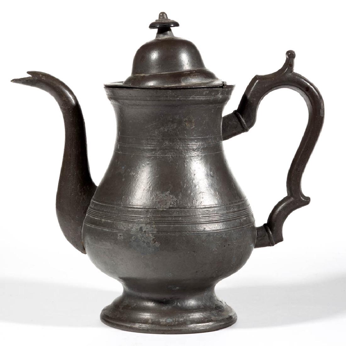 AMERICAN PEWTER COFFEE POT: AMERICAN PEWTER COFFEE POT, baluster-form body with banded decoration, double-scrolled handle with thumbrest, domed lid with ebony finial. Unmarked. First half 19th century. 10 3/8" HOA.Good overall c