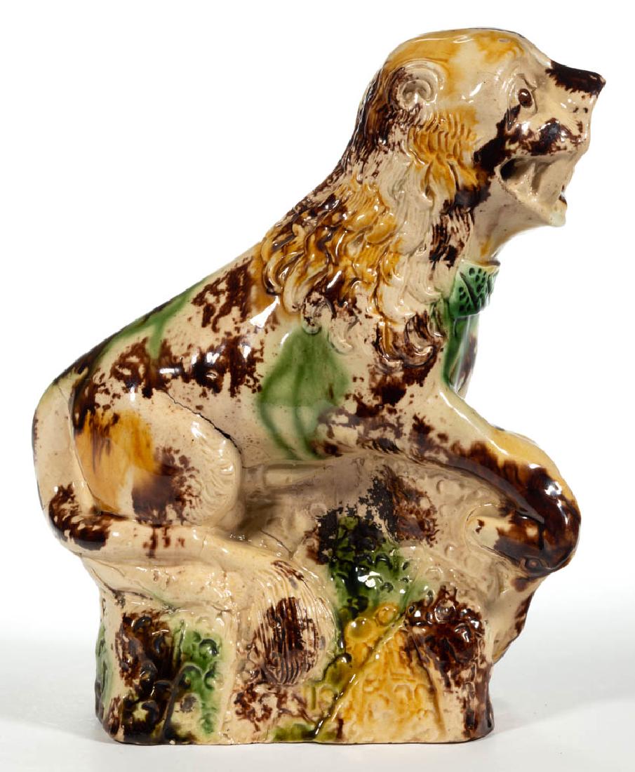 ENGLISH STAFFORDSHIRE WHIELDON-TYPE CREAMWARE CERAMIC: ENGLISH STAFFORDSHIRE WHIELDON-TYPE CREAMWARE CERAMIC CHINESE FOO DOG / LION, sitting on a molded rectangular base, with front legs resting on a deer-like animal, having an expressive face with mouth