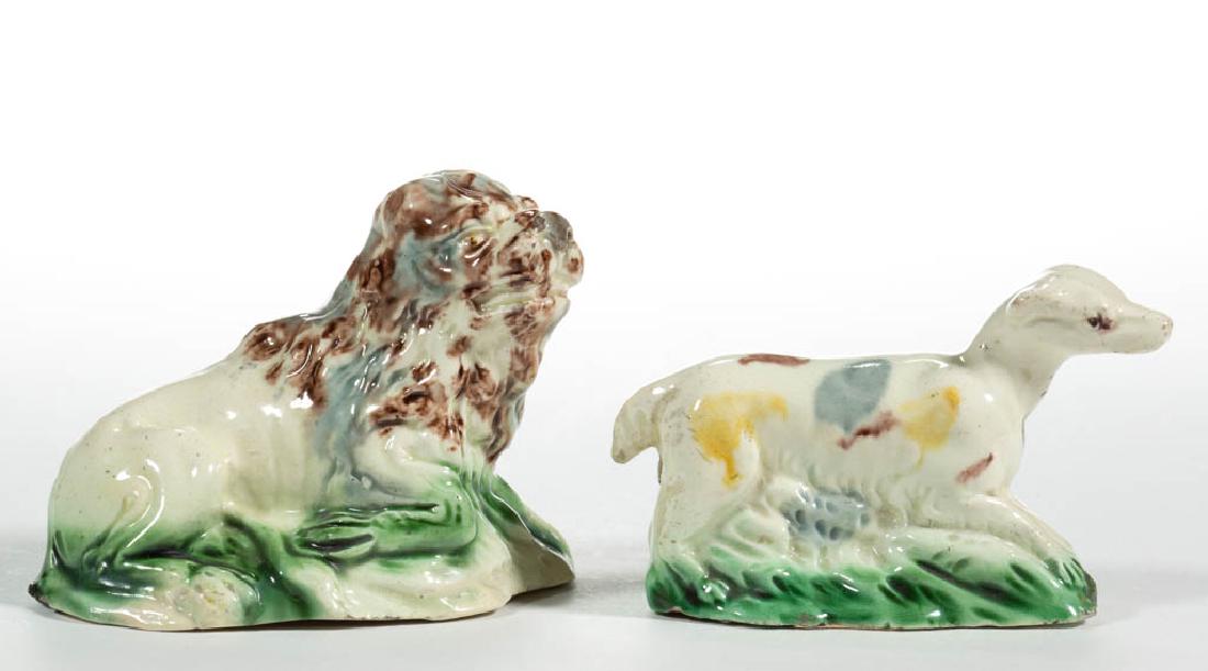 ENGLISH STAFFORDSHIRE WHIELDON-TYPE CREAMWARE CERAMIC: ENGLISH STAFFORDSHIRE WHIELDON-TYPE CREAMWARE CERAMIC FIGURES, LOT OF TWO, comprising a recumbent lion on molded base with one leg folded to side and a dog standing on a molded ovoid base having a sho