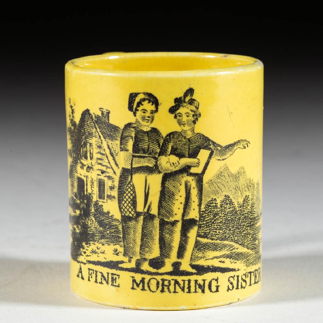ENGLISH STAFFORDSHIRE CANARY WARE TRANSFER-PRINTED: ENGLISH STAFFORDSHIRE CANARY WARE TRANSFER-PRINTED CERAMIC CHILDREN'S TOY MUG, having yellow ground and black transfer design featuring two figures standing in front of a house with "A FINE MORNING SI