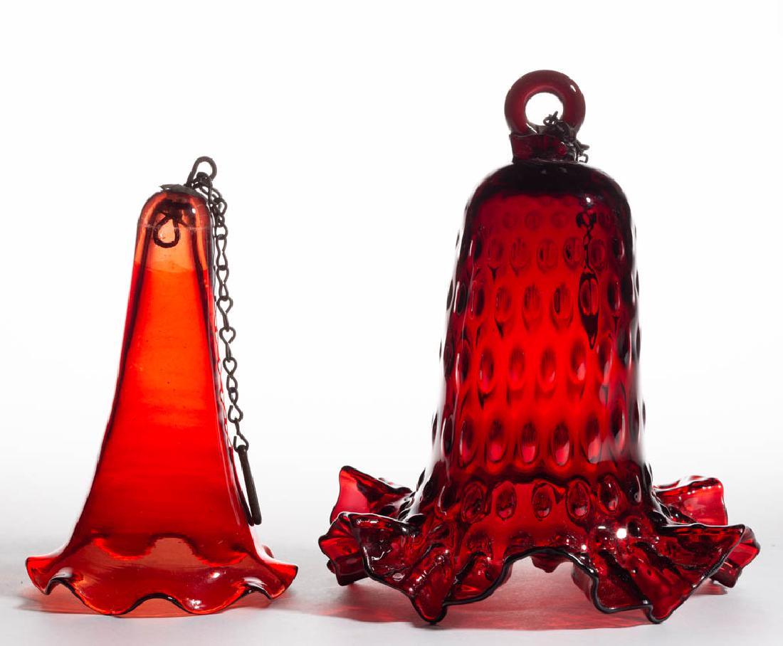 BLOWN CRANBERRY GLASS SMOKE BELLS, LOT OF TWO: BLOWN CRANBERRY GLASS SMOKE BELLS, LOT OF TWO, including a Hobnail / Dew Drop example, Hobnail with applied hanging ring with the other having a period metal cap and hanging ring. Various makers. Four