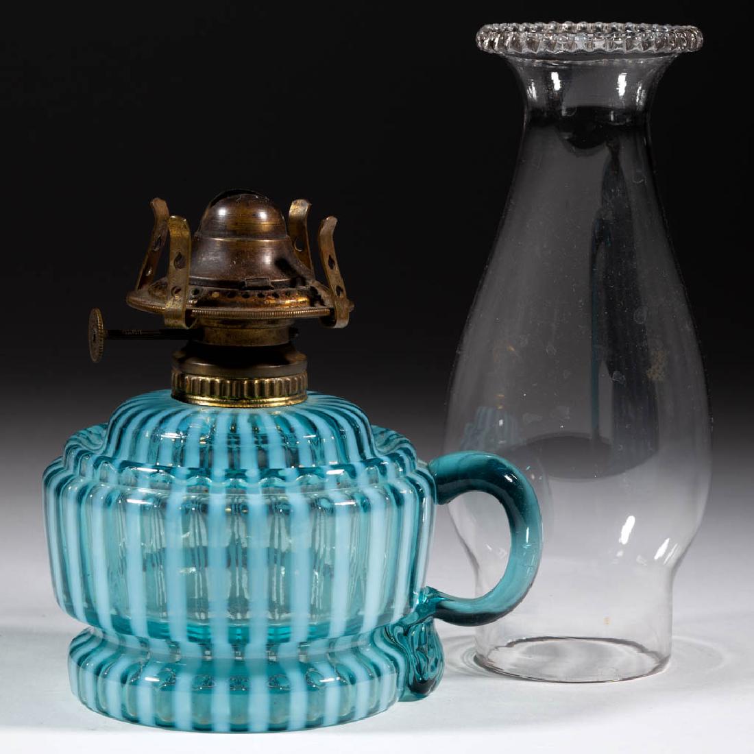 MARKHAM SWIRL BAND - STRIPES KEROSENE FOOTED FINGER: MARKHAM SWIRL BAND - STRIPES KEROSENE FOOTED FINGER LAMP, blue opalescent, without molded swirls on body, blue applied handle with pressed rib pattern to lower terminal, No. 1 Fluted-Band collar. Fitt