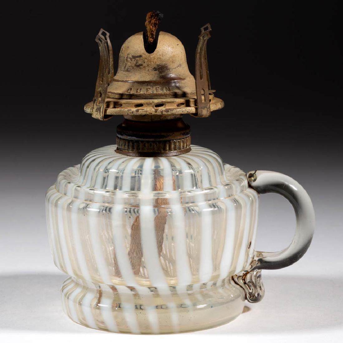 MARKHAM SWIRL BAND VARIANT KEROSENE FINGER LAMP: MARKHAM SWIRL BAND VARIANT KEROSENE FINGER LAMP, colorless opalescent Stripe font lacking central diagonal ribs, applied handle, No. 1 Fluted Band collar. Fitted with a period No. 1 "QUEEN ANNE" slip 