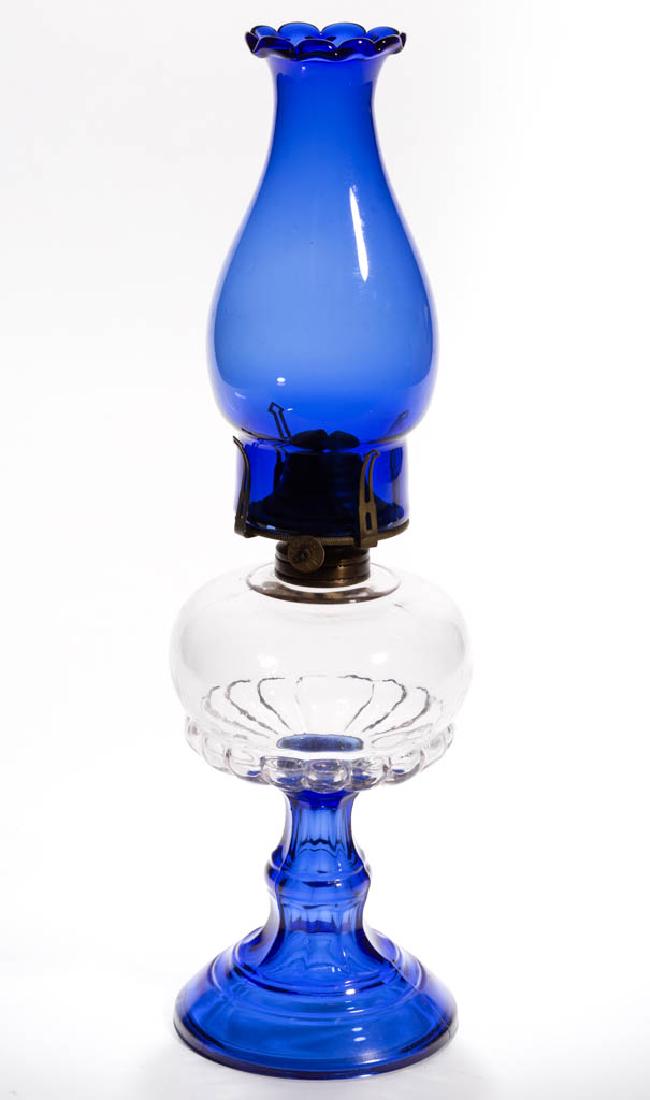 HOBBS FULL-RIB KEROSENE STAND LAMP: HOBBS FULL-RIB KEROSENE STAND LAMP, colorless font, sapphire blue base No. 1 Taplin-Brown collar. Fitted with a period setup comprising a No. 1 slip burner and a cobalt blue chimney with ten-petal top