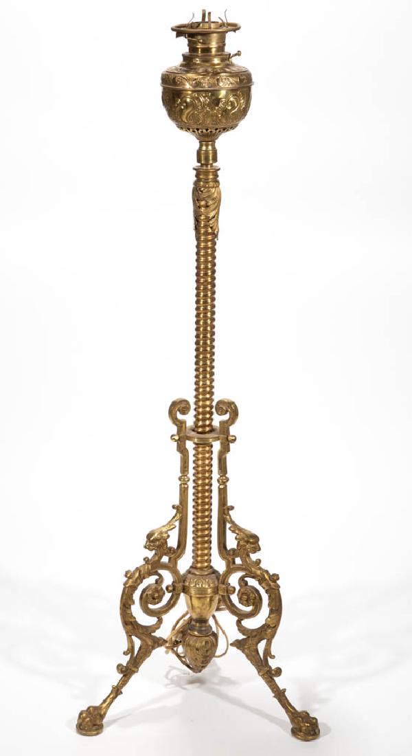 "THE HAIDA" / R. HOLLINGS & CO. BRASS PIANO LAMP: "THE HAIDA" / R. HOLLINGS & CO. BRASS PIANO LAMP, stamped brass scrolling font signed "THE HAIDA" to the collar, raised on an adjustable spiraling shaft terminating in a double-acorn bottom finial, ca