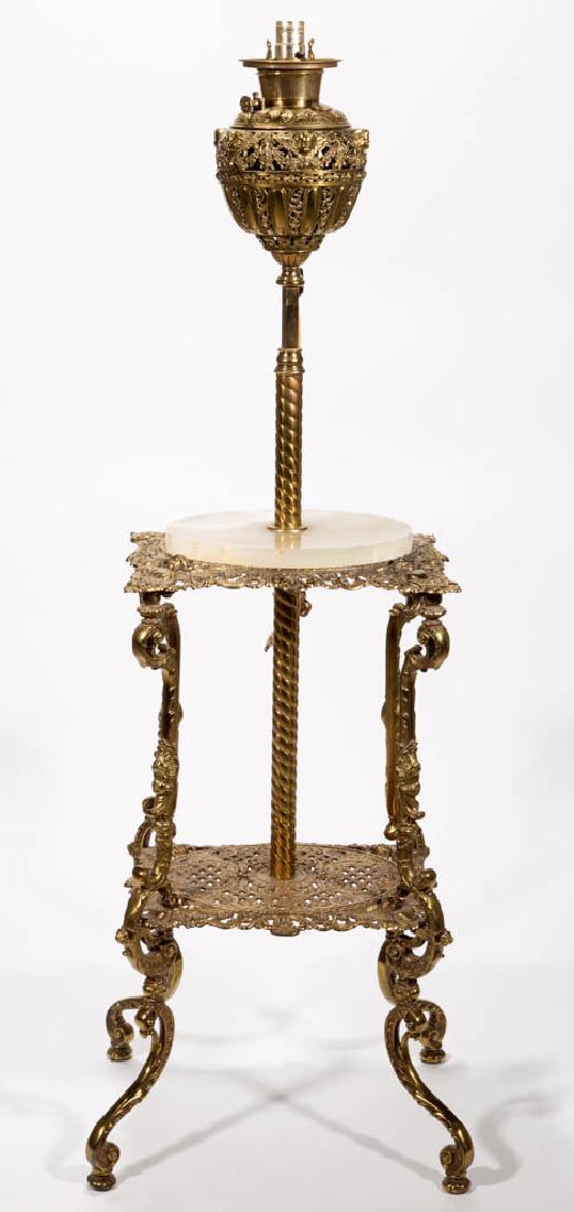 VICTORIAN CAST-BRASS PIANO LAMP: VICTORIAN CAST-BRASS PIANO LAMP, cast-brass openwork Gothic Cherub font vase, fitted with a period "B&H" brass drop-in font, raised on an adjustable spiral shaft piercing a central oval marble plateau