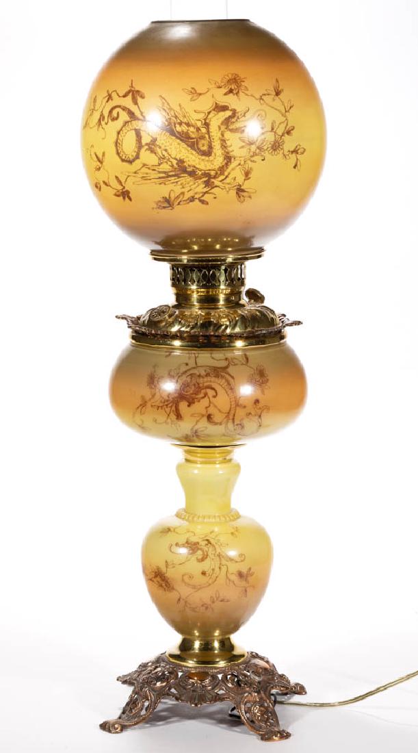 VICTORIAN STENCIL-DECORATED GONE WITH THE WIND / PARLOR: VICTORIAN STENCIL-DECORATED GONE WITH THE WIND / PARLOR LAMP, opal with butterscotch tones and winged griffin transfer, globular-form vase with drop-in brass font, cast-metal base with underside impre