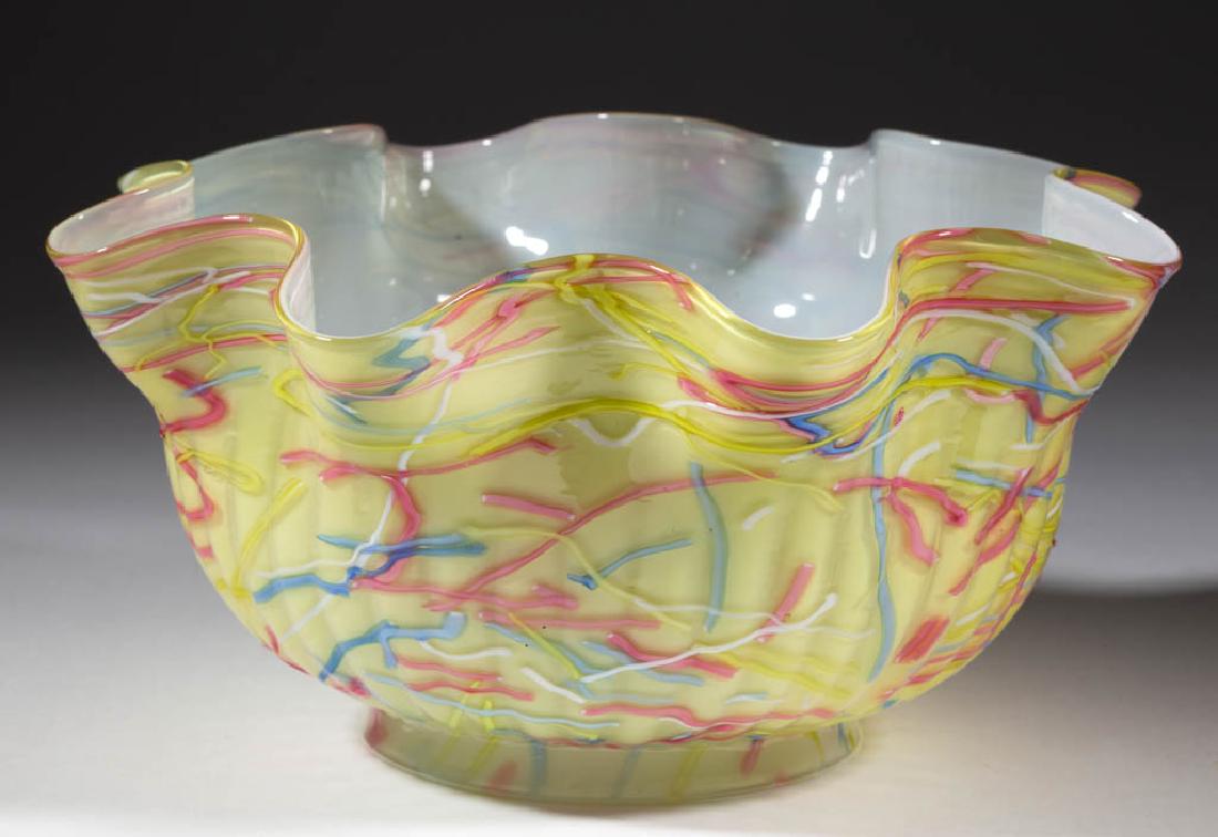 PELOTON CASED GLASS LAMP SHADE: PELOTON CASED GLASS LAMP SHADE, lemon yellow cased with polychrome applied threads, gas shade with a ribbed pattern and gauffered rim. Maker unverified. Late 19th/early 20th century. 4 1/2" H, 8 5/8" 
