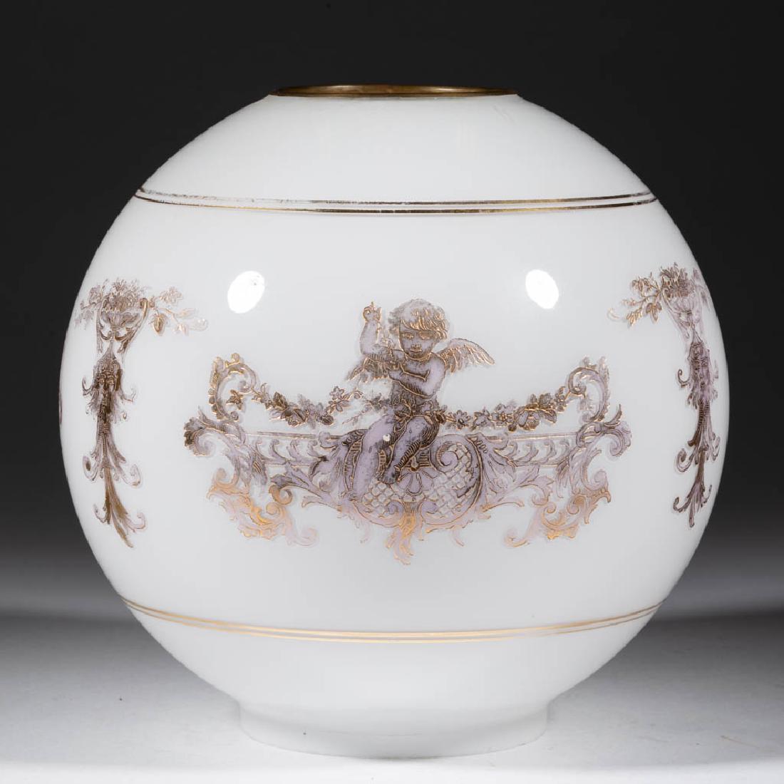 GILT DECORATED AND CASED GLASS LAMP SHADE: GILT DECORATED AND CASED GLASS LAMP SHADE, colorless cased opaque white, ball form with Gothic cherub and gargoyle decoration, original shade ring. Maker unverified. Late 19th/early 20th century. 8 1/